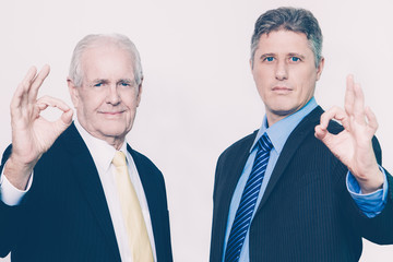 Portrait of confident men showing ok sign