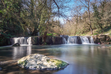 long exposure of a lake and waterfalls in the natural park of "Monte Gelato" 40 km away from Rome, Italy