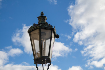 Fototapeta na wymiar Traditional street lamp - lantern and a blue sky with clouds