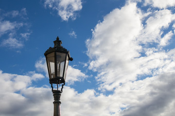 Traditional street lamp - lantern and a blue sky with clouds