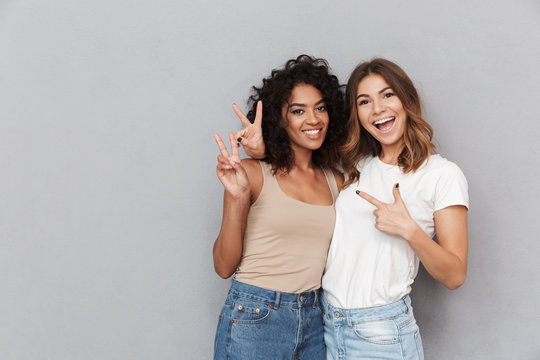Portrait of two cheerful young women standing together