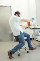 Dentist stretching arms in his office - healthy lifestyle at work