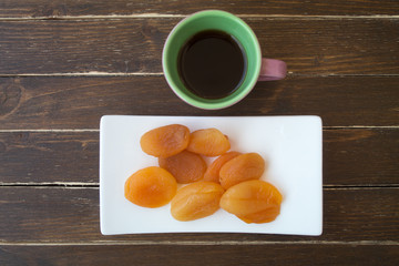 Pitted apricots on a wooden table viewed from above
