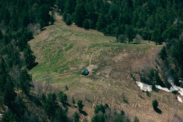 Travelers spend the night in a lonely house on the Caucasus mountain, in the forest.