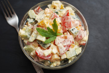 Vegetable Salad Bell Pepper, Tomato, Cucumber, Eggs and Mayonnaise. Health Vegan salad. Glass Bowl Black Board.