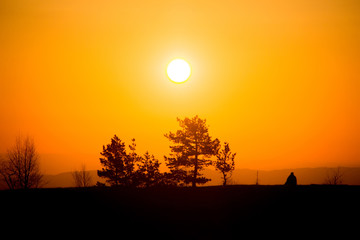 A traveler meets the dawn in the mountains of the Caucasus.