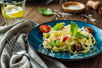 Tagliatelle pasta with cherry tomatoes, basil and frsh grated gran padano cheese
