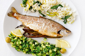 roasted stuffed freshwater trout with leek spinach rice and cucumber onion salad