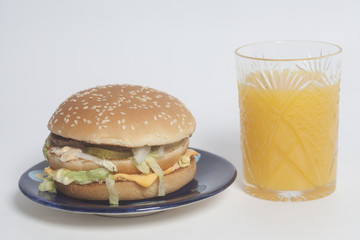 Tasty Big burger and glass of orange juice