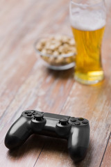 Obraz premium gaming, technology and entertainment concept - blue gamepad controller on table