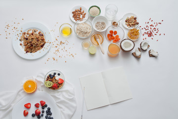 Ingredients for a healthy breakfast - granola, honey, nuts, berries, fruits, top view.