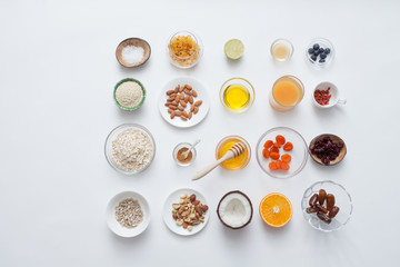 Ingredients for a healthy breakfast - granola, honey, nuts, berries, fruits, top view.