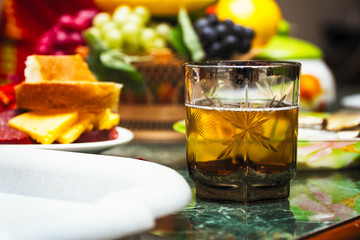 A glass of drink on the table with fruit