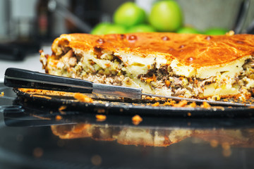 Meat pie on plate and knife