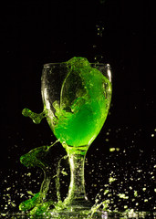 Fototapeta na wymiar Pour green water into a glass,Water splash in glass