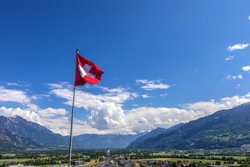 Swiss flag over the Alps in Switzerland