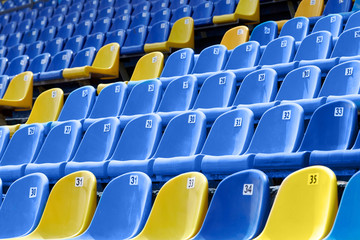 Yellow and blue plastic seats in the stadium.