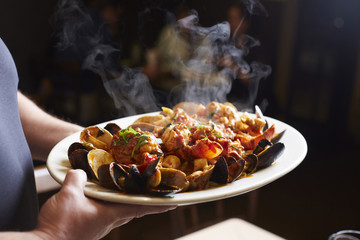 Midsection of woman holding food in plate while standing at home