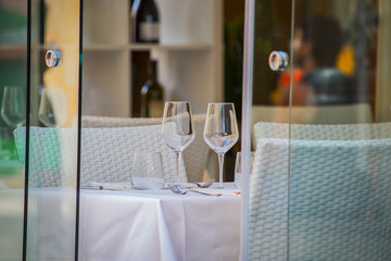 close up of pair of goblet glasses on table