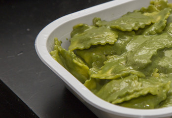 horizontal image of close-up of fresh pasta with pesto sauce