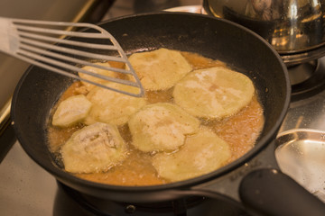 horizontal image of close-up of fried aubergines in a pan