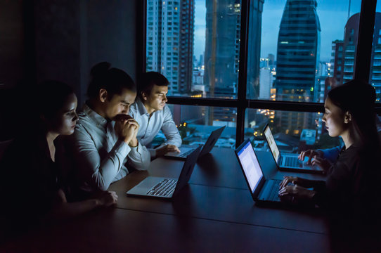 businesspeople working overtime in nighttime at the office.