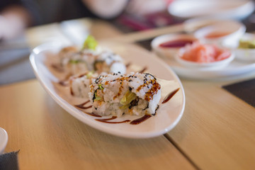 closeup of chinese sushi food with spicy sauces