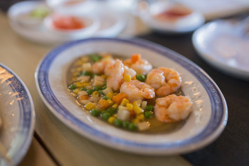 closeup of dish with chinese food shrimp stewed with peas and corn
