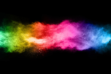 Multicolor powder explosion on black background. 