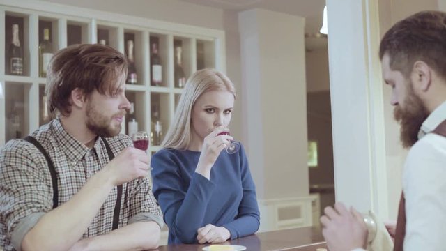 Beautiful couple in a restaurant. Cheerful couple in restaurant making an order. Romantic couple dating in pub