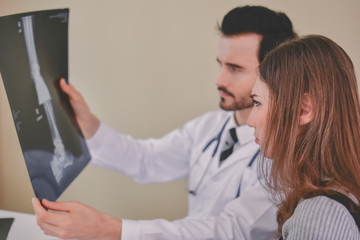 Health Concepts. Doctor and patient viewing x-ray film. The doctor and the patient feel relaxed at the check-in time. The doctor encouraged the patient. Inside the hospital are doctor X-ray patient.