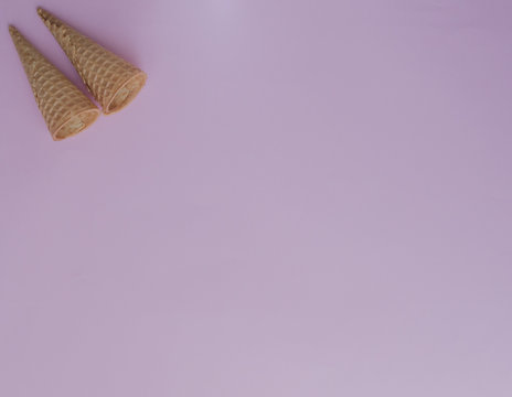 Ice cream cones on pink background with copy space