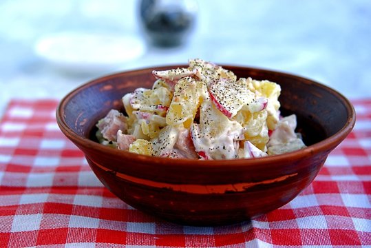 Sour potato salad with ham and radish. Served with a sauce of mayonnaise, sour cream and granular mustard.