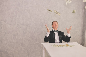 Concept Very wealthy businessman. Businessman is happy with his money.A businessman showing his...