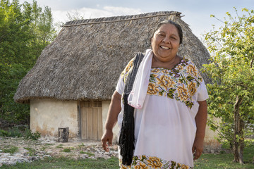 Traditional Mayan Clay House with smiling woman 