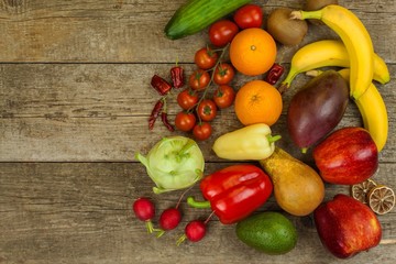 Different types of vegetables and fruits on a wooden table. Concept of healthy food. Dietary foods.