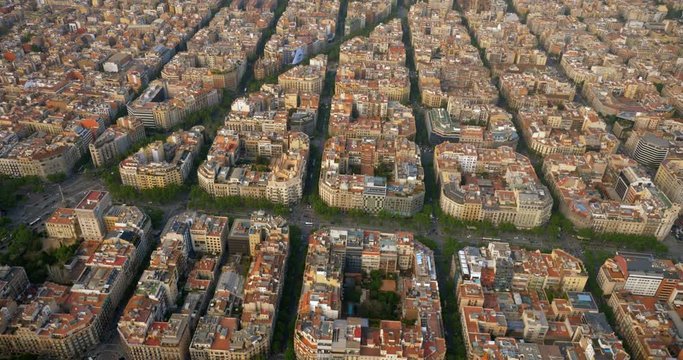Flying above Barcelona Eixample residential district with typical square urban grid, Spain