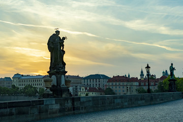 view of Prague from the karlogo bridge with a statue