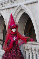 Fototapeta na wymiar face mask red carnivale artist dress suit magic carnivale Venezia