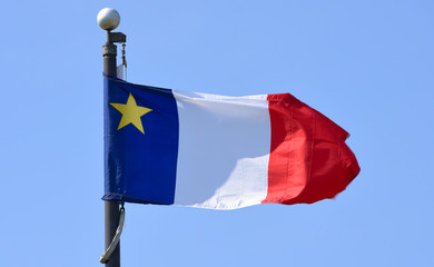 Flag of Acadia flying in Wolfville, Nova Scotia, Canada. The Flag of Acadia was adopted on August 15, 1884 in memory of the Acadian delegates.