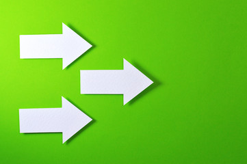 three solid arrows on green background