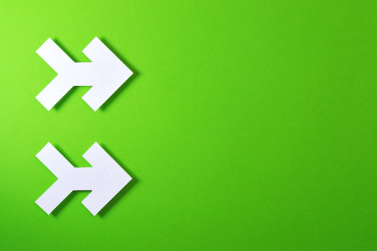 two arrows on green background