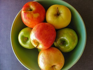 Large bowl of crisp autumn apples in tones of red, green and yellow