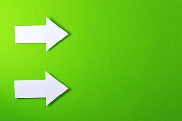 two solid arrows on green background
