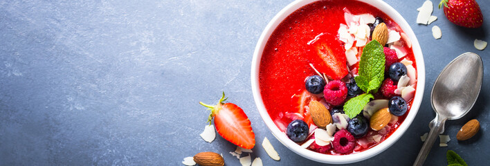 Smoothie bowl with fresh berries and nuts. 