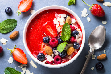 Smoothie bowl with fresh berries and nuts. 