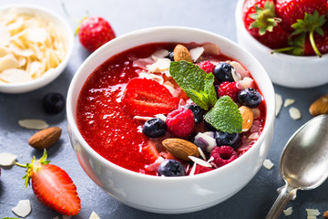 Smoothie bowl with fresh berries and nuts. 
