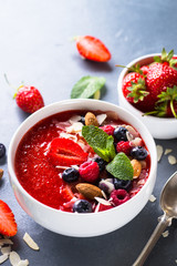 Smoothie bowl with fresh berries and nuts. 