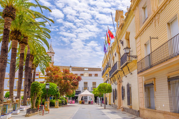 A view along the side of Plaza de la Laguna with the town hall on the right, looking at Parroquia de las Angustias church in Ayamonte, Andalusia, Spain