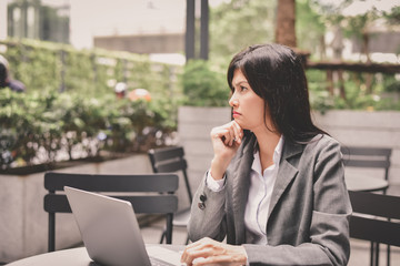 Business Concept.Young Asian businesswoman is working happily.Young businesswoman working in a cafe.Young businesswoman is relaxation in a coffee shop.